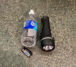 Water bottle, batteries, flashlight