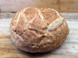 Loaf of sourdough bread on cutting board.