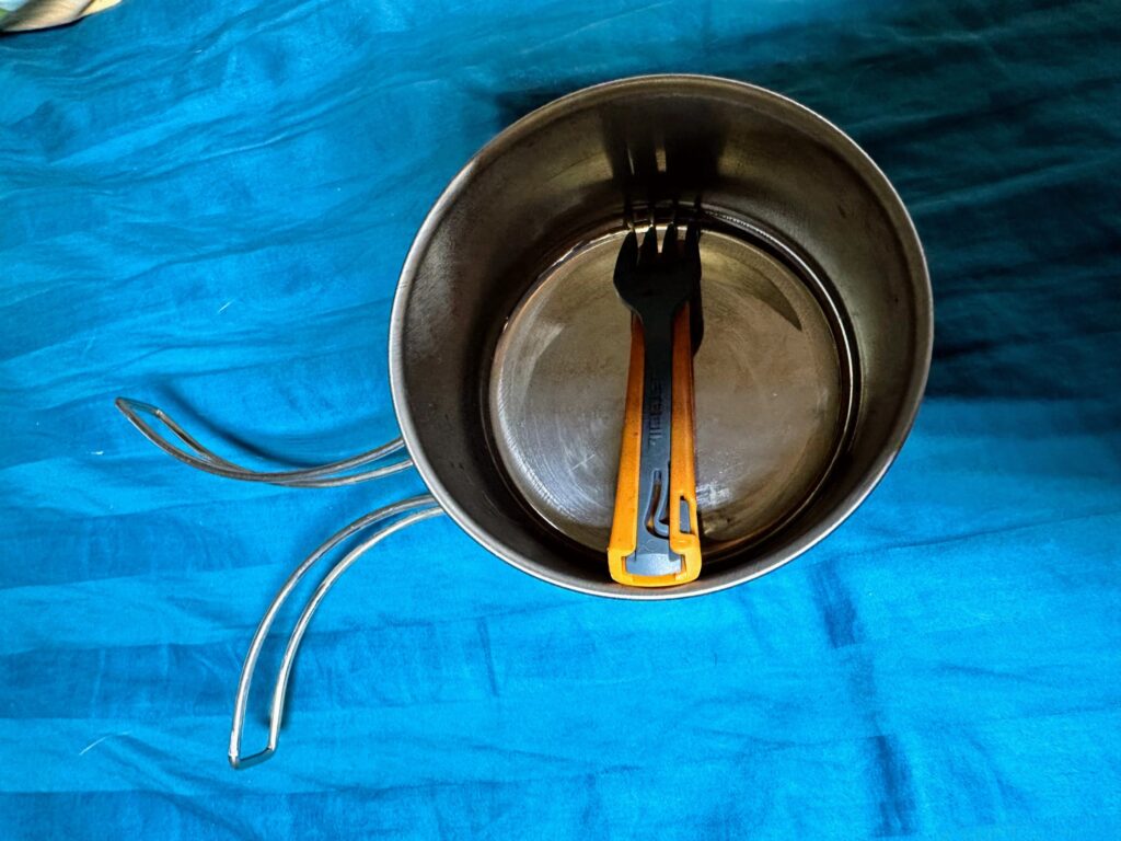 Camping pot with folding fork